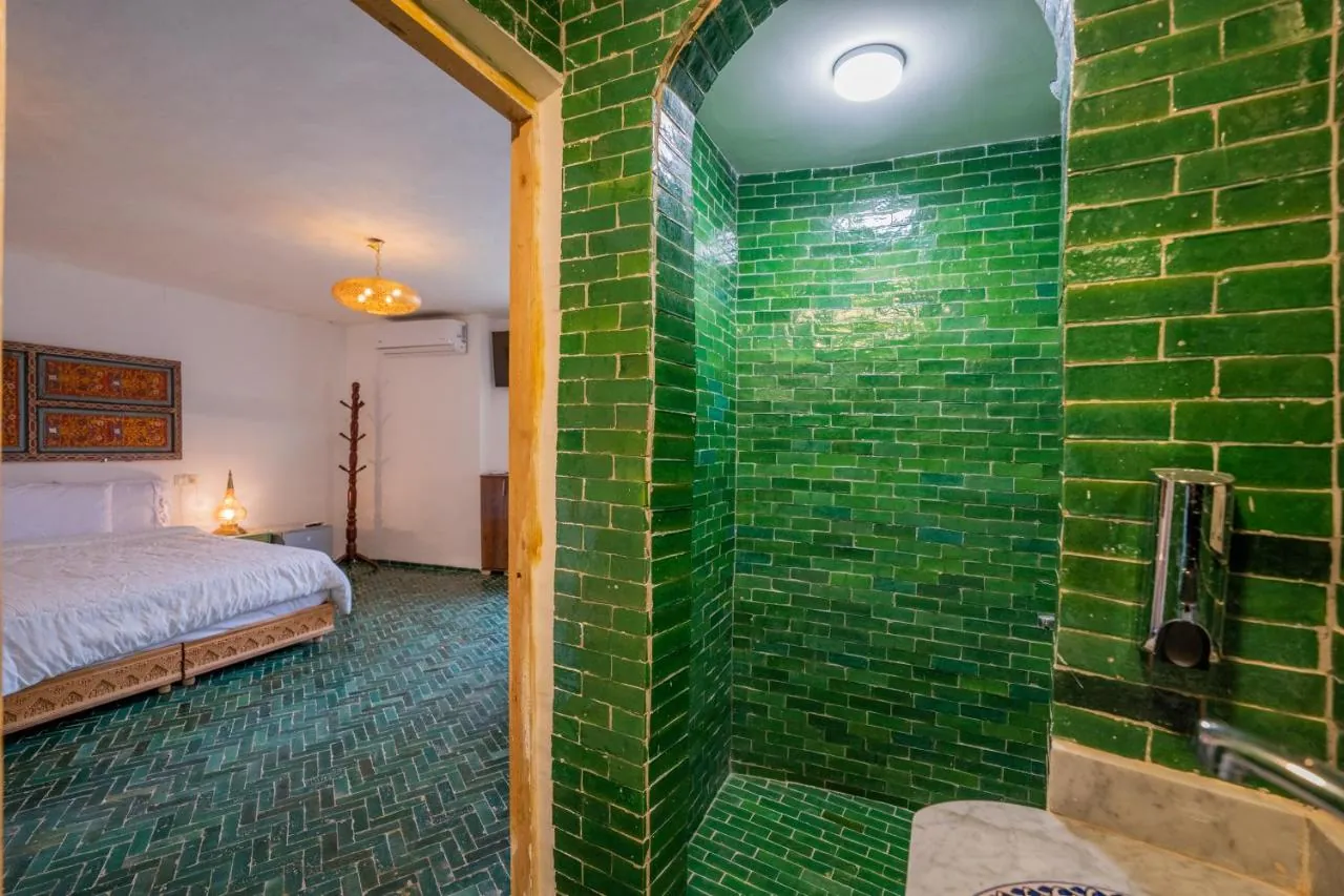 Guest bathroom finished in emerald Moroccan tile