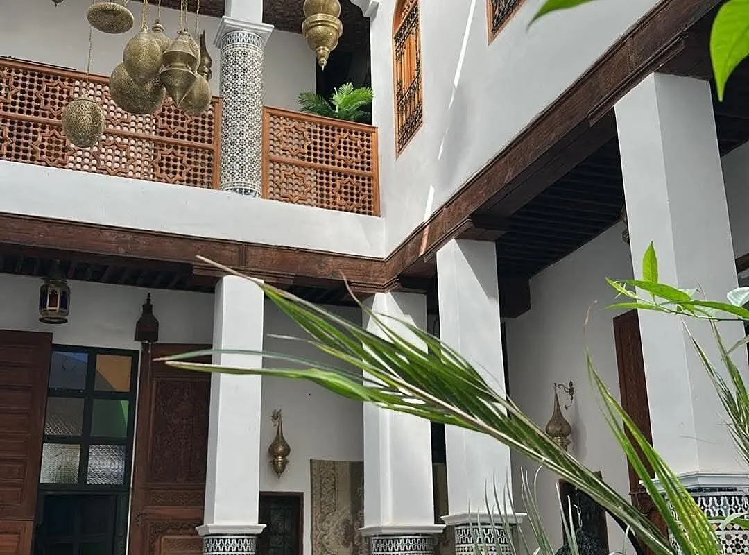 Carved cedar and white-plaster courtyard architecture