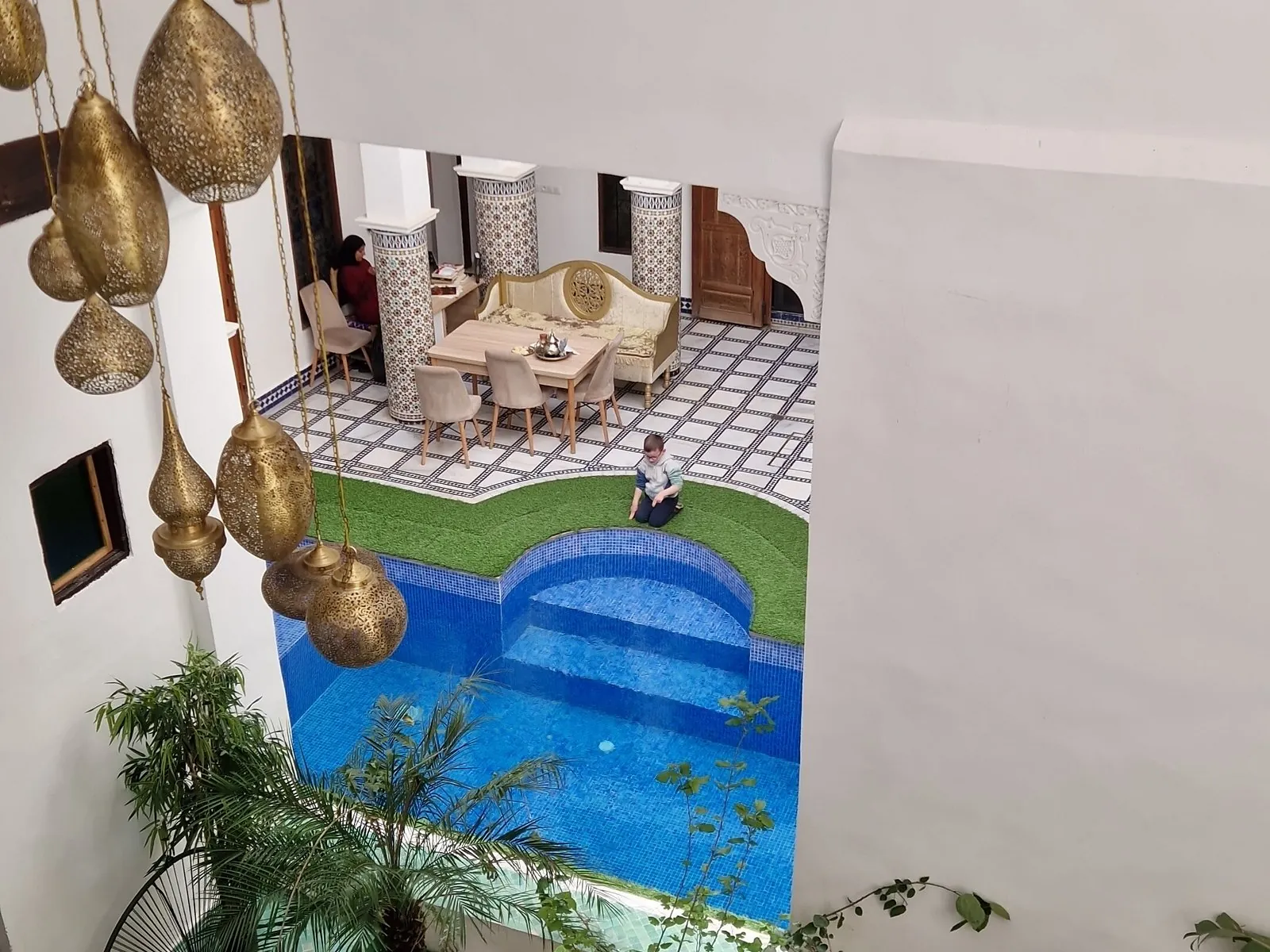 Looking down on the courtyard pool and hanging brass lanterns