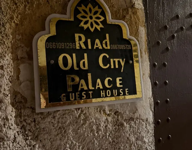 Carved street plaque reading Riad Old City Palace