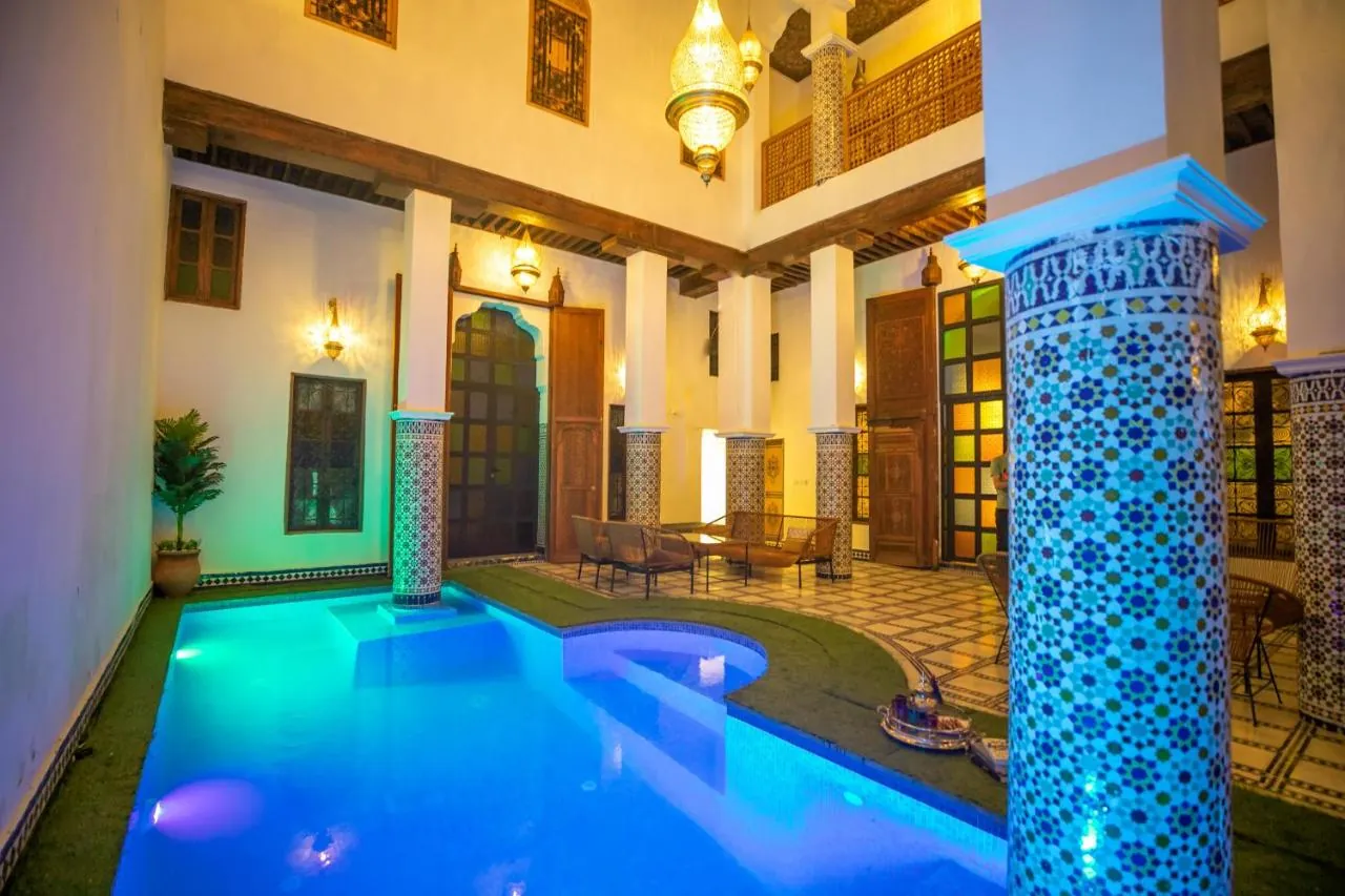 Illuminated indoor courtyard pool at Riad Old City Palace